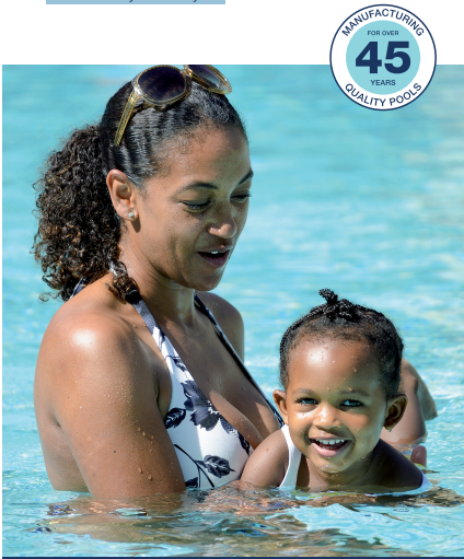 A mother and child happily swimming in a pool.